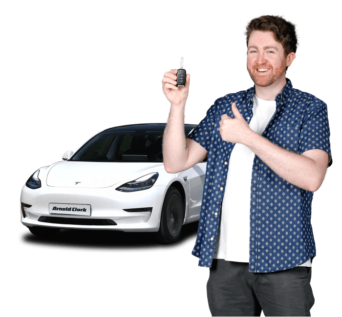 Man holding a car key infront of a white car